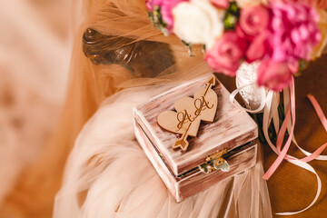 Wooden box for wedding rings with monogram of capital letters of the name in the heart on the...