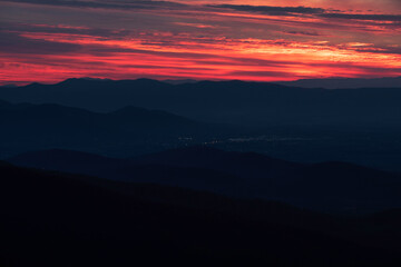 Neon like reds and oranges at sunset over the darkened valleys of Shenandoah National Park.