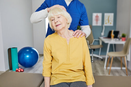 Pain in older woman neck vertebrae and rehab at a medical center - Powered by Adobe