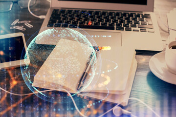 Multi exposure of world map drawings and desk with open notebook background. Concept of globolization