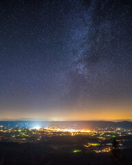 The night sky over the town lights of Luray, Virginia nestled in the center of the Shenandoah Valley, viewed from Shenandoah National Park.