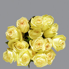Bouquet of yellow tender roses on a gray background. Greeting card for mother's day, birthday, wedding day.