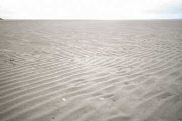 Fototapeta na wymiar Sand beach with the coast of Dublin, Ireland.