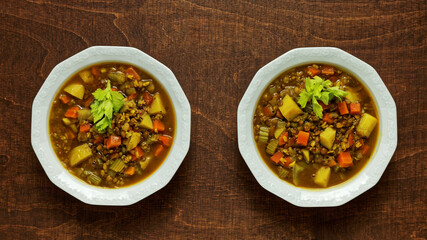 Homemade soup with various ingredients: urid dal gota and brown lentils, freekeh cereal and vegetables. Flat lay.