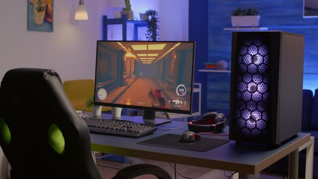 Empty gaming romm with RGB professional keyboard, mouse and headset. Pro gamer using powerful computer for first person shooter tournament late at night in home studio