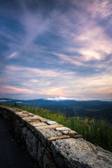 Cotton candy high clouds over the valleys of Virginia around Shenandoah National Park with a low white cloud in the distance.