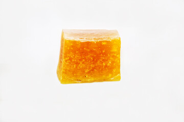 Yellow paraffin isolated on a white background, a waxy mixture of marginal hydrocarbons (alkanes) to pentatriocontane. Paleontology Late Jurassic fossils.