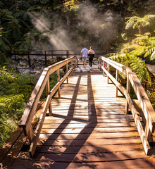 Couple at Caldeira Velha, Azores travel destination.