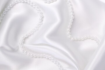 pearl necklace on a satin background
