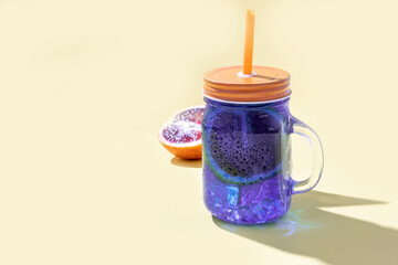 thai blue iced tea with a slice of red orange