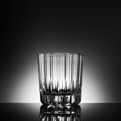 Transparent elegant empty glass of whiskey backlit
