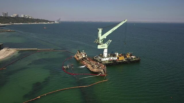 ODESSA, UKRAINE, September 2, 2020. Aerial shot rescue operation of submerged oil tanker Delfi run aground near public beach after storm in Black Sea. Shipwreck with oil spill, ecological distaster