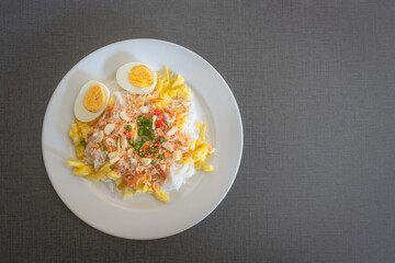 Thai rice noodles with pineapple and coconut milk the delicious of traditional food served on white plate in Thai name is Kanom Cheen Saw Num.