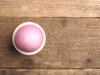 Naturally colored organic egg on a rustic table