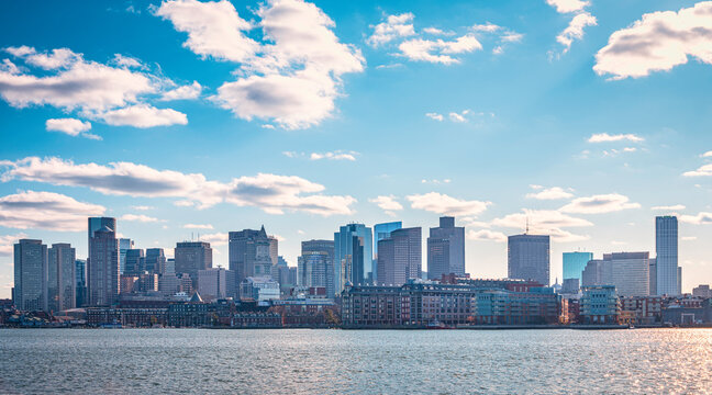 Boston Cityscape over the Charles River with Dramatic Clouds on Blue Sky Background
