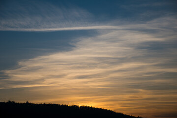 colorful sunset with clouds over the mountains