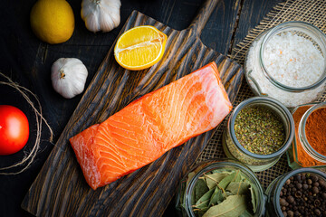 Fresh raw chilled salmon fillet on a woodencutting board. Healthy eating, seafood recipe ingredient.