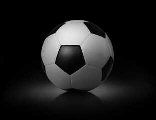 Fototapeta na wymiar Soccer ball on black background sports team