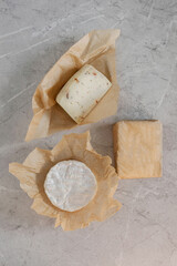 Homemade fresh cheese on gray concrete background, top view.