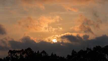 Sunrise with sun seeming to hover inside clouds