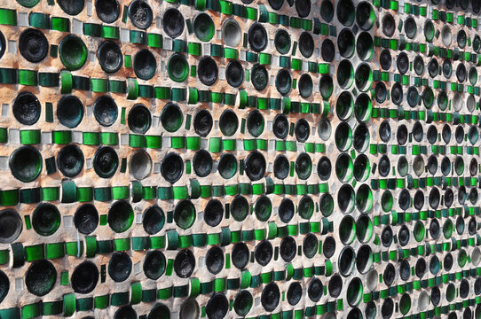 A Glass Bottle Wall Of A Colored Bottle Building Made From Eco-friendly, Upcycled Building Materials Glass Bottles And Mortar.