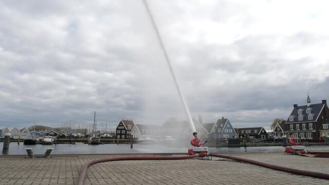 Fire brigade exercise water jet hoses in Dutch harbor Huizen