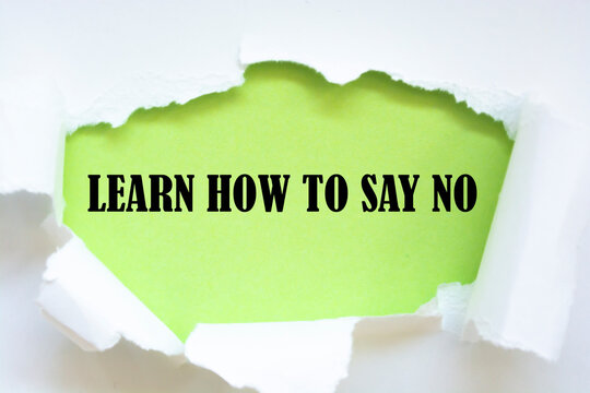 LEARN HOW TO SAY NO Message Written Under Torn Paper.