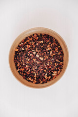 Dry fruit tea in a wooden plate on a white background. Top view. Copy, empty space for text