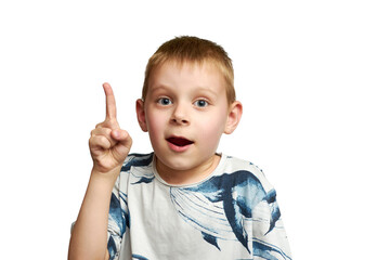 Portrait of a little boy excited with an idea. A boy holds his index finger up isolated on a white background.