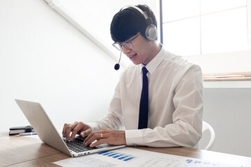 young confident male call center operator customer service representative doing his job on the phone with headset.
