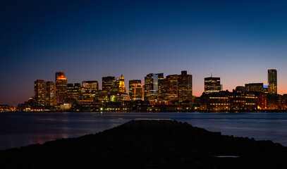 Naklejka premium Night Cityscape Boston Skyline and Sea Reflections from LoPresti Park in Boston, Massachusetts