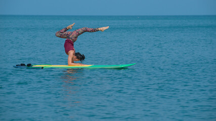 Young yogini practicing on the floor in room. person doing exercise.