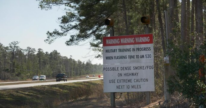 A flashing military live fire warning sign near a North Carolina highway.  	