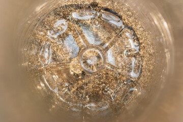 Closeup of clear plastic water bottle on natural background.