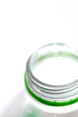 Closeup of clear plastic water bottle on white background.