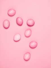 Creatively painted eggs in pastel colors on pink background. Happy Easter concept. Flat lay.