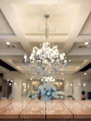 Empty wooden table top with lights bokeh on blur restaurant background.