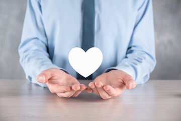 Businessman in shirt holding heart icon symbol