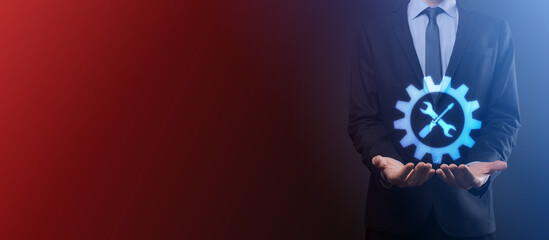 Businessman holding gear icon with tools.Gearing.Concept of target focus digital diagram,graph interfaces,virtual UI screen,connections netwoork.