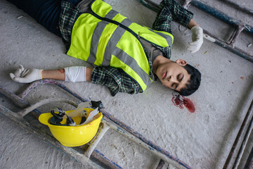 Accident builder fall scaffolding to the floor. Safety first and accident at work concept. Employee unconscious head injuries.