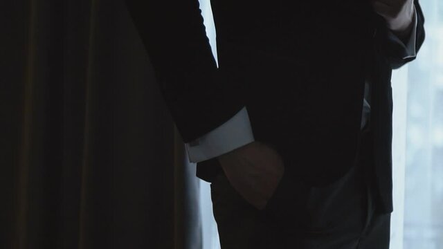 man straightens his suit