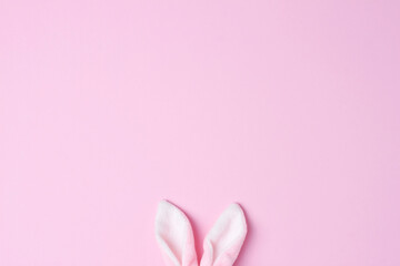 Bunny ears on pink background. Flat lay, copy space