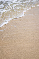 Wave on sandy beach with copy space for your text, high angle view background.