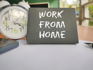 Business Concept - WORK FROM HOME text in vintage background. Stock photo.