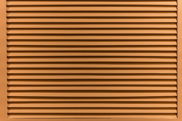 The texture of the wall is made of metal coating of huge aluminum plates of relief shape with horizontal notches. A variety of metal siding close-up