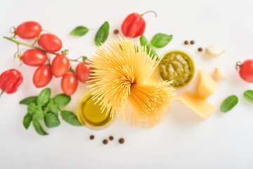 Spaghetti, fresh tomato, herbs and spices. Composition of healthy food ingredients isolated on white background, top view. Mock up.