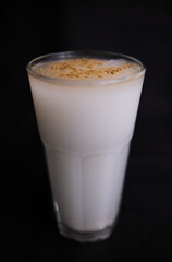 Glass of traditional Mexican horchata water with black background