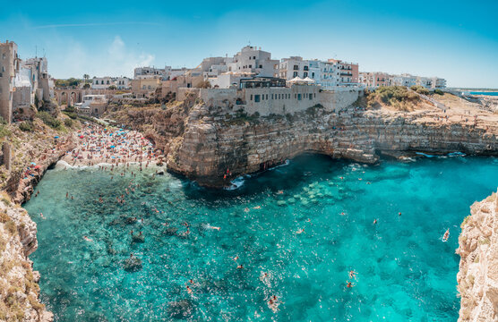 panorama of the famous and crowded Lama Monachile Beach in Polignano a Mare, Puglia