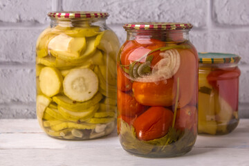 Jars of canned vegetables on a wooden background . Homemade vegetables for the winter
