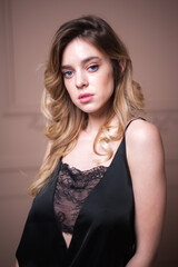 Beautiful brunette young woman posing in lingerie. Ideal slim sexy body. Girl with long hair. 